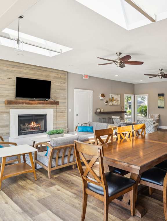 A dining room with a wooden table and chairs.