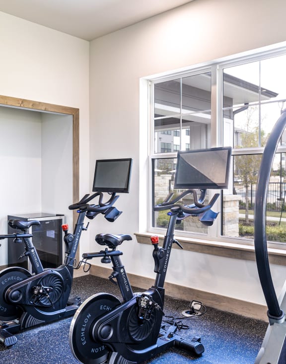a gym with exercise bikes and a treadmill
