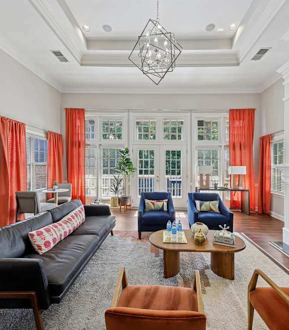 A living room with a black couch and a fireplace.