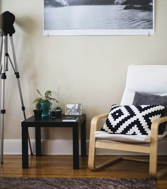 a desk with a chair and a lamp in a room