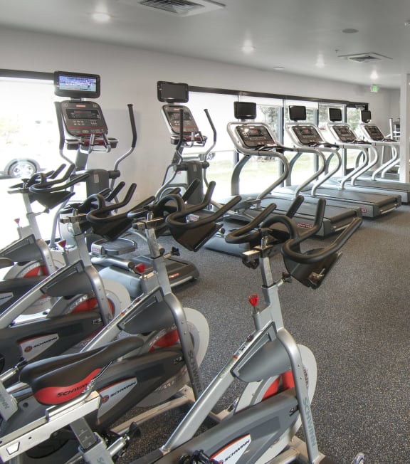 a gym full of cardio equipment and exercise machines at Cycle Apartments, Colorado, 80525