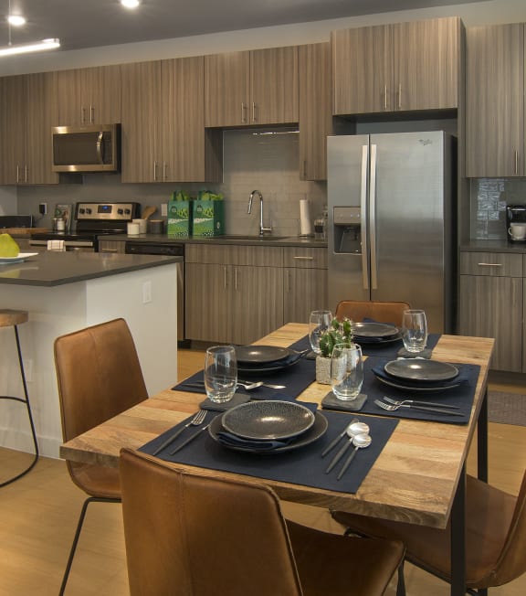 a kitchen and dining room with a table and chairs at Cycle Apartments, Colorado, 80525
