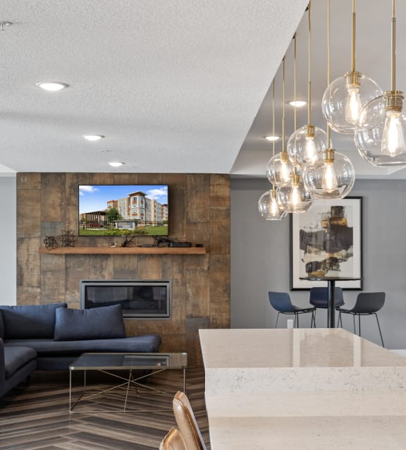 a living room with couches and a table and a kitchen