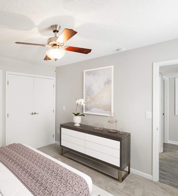 Hunters Pointe Apartments in Charlotte North Carolina photo of a bedroom with a bed and a ceiling fan