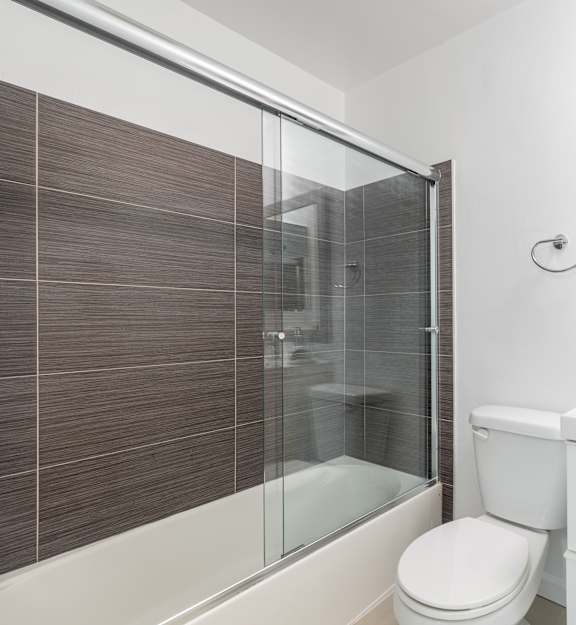 A white toilet sits next to a sink in a bathroom.