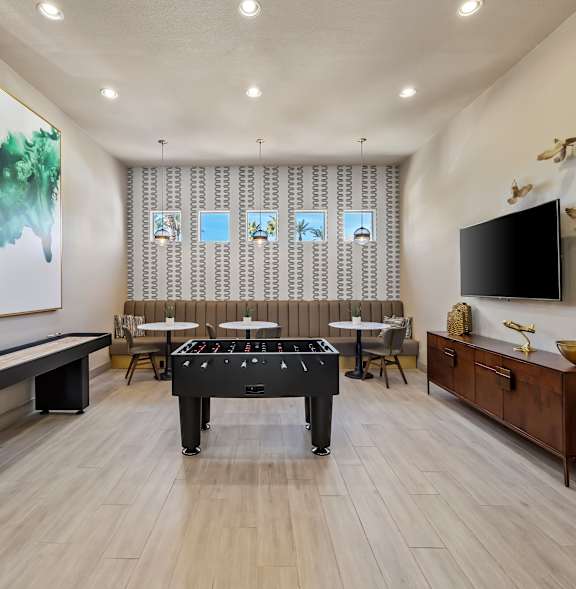 A room with a pool table and a painting on the wall.