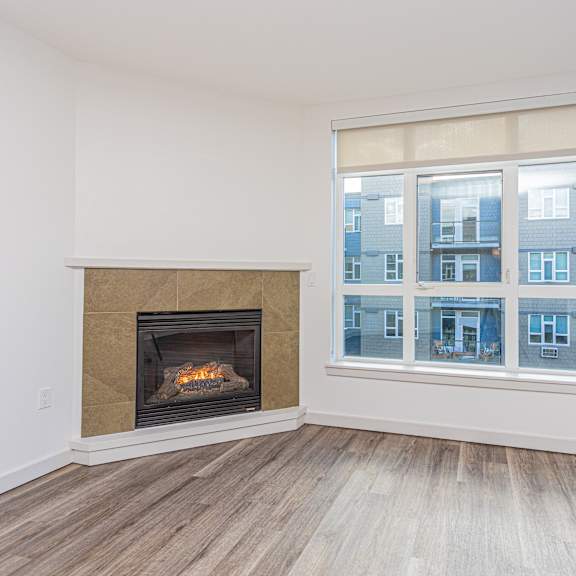 a private patio with a wood slatted privacy fence in front of an apartment building at 128 on State, Kirkland, 98033