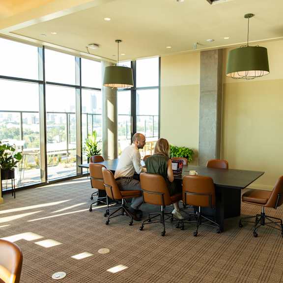 Two People sitting at conference room table at Scout Living, powered by Placemakr, Georgia