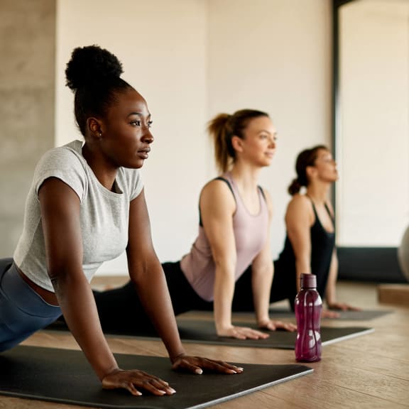 a group of women doing yoga in a gym at Radbourne Lake Apartments, Charlotte North Carolina