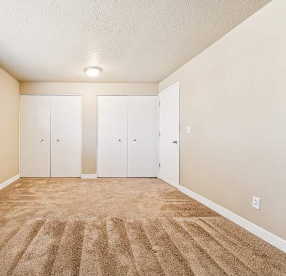 A room with carpeted floor and white walls.