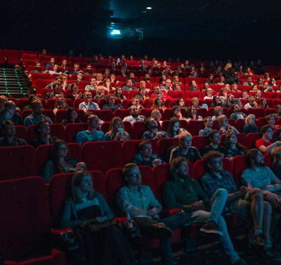 a crowd of people sitting in a theater