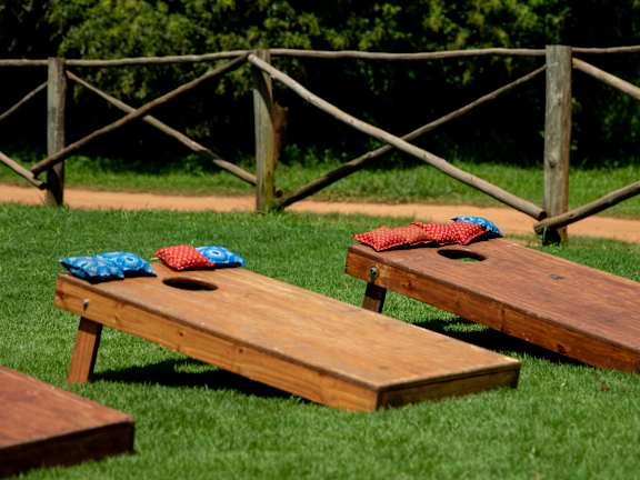 Picnic tables with red and blue cloths on them.