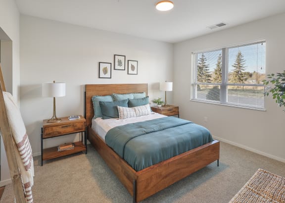 a bedroom with a bed and a large window