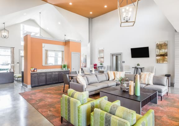 a living room with couches and chairs and a table