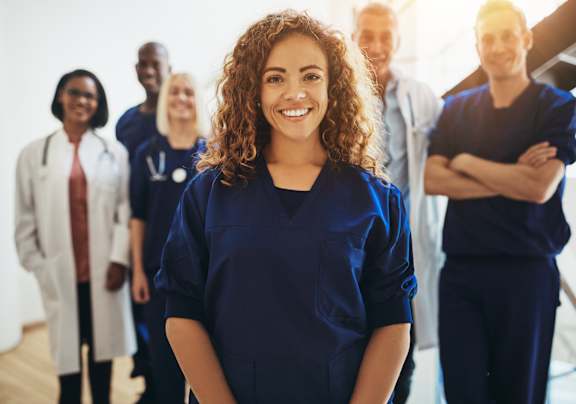 A group of medical professionals are standing in a line.