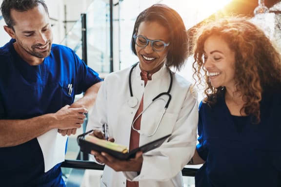 a group of doctors shaking hands with a patient in a hospital