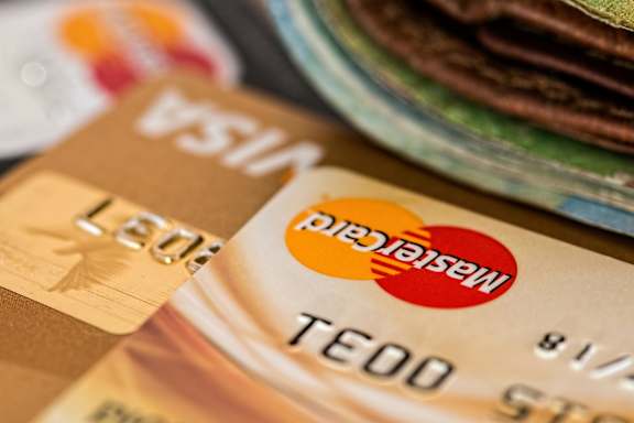 A close up of a MasterCard and a Visa card.