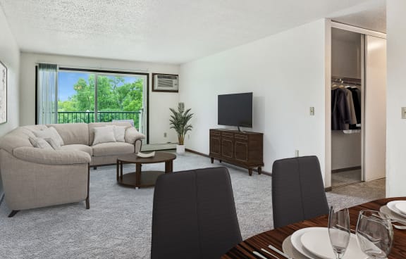 a rendering of a living room with a large window and a balcony