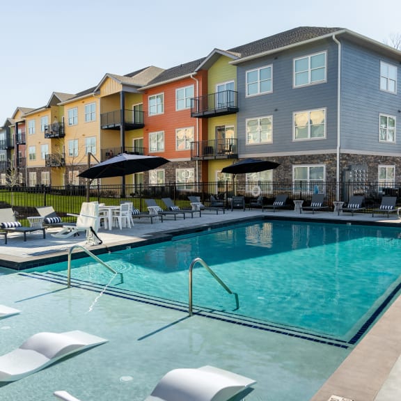 a swimming pool with a building in the background