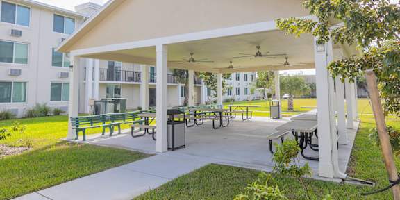 A white building with a covered patio area.