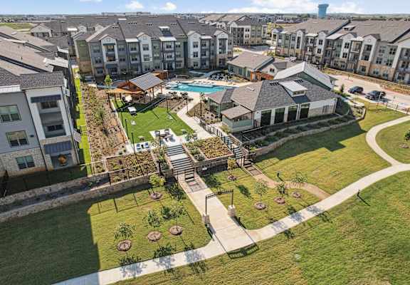 A large grassy area with a building and a pool.
