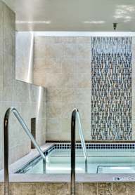 a large jacuzzi tub in a bathroom with a water feature at Crosby Pointe Apartments, Minnesota