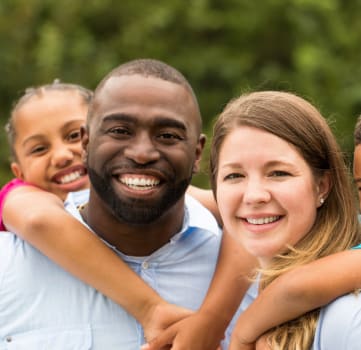 a family of four smiling at the camera
