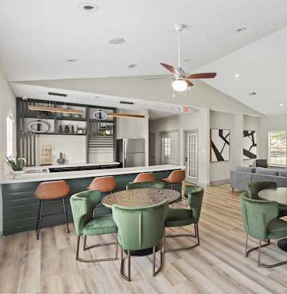 A modern dining room with a bar area and a television.