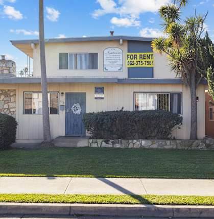 A house with a for rent sign on the front.
