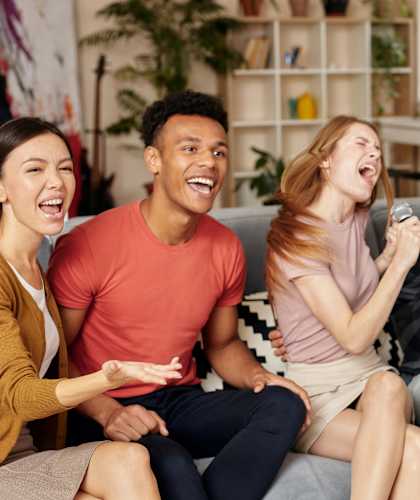 A group of friends are singing and having fun together.
