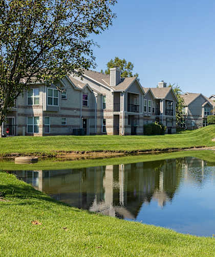 The exterior of Hawthorne Apartment Homes, featuring a well-kept building with lush landscaping.
