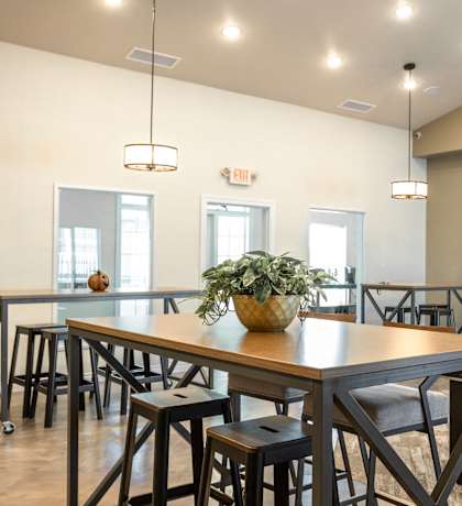 a dining room with a table and chairs and a projection screen
