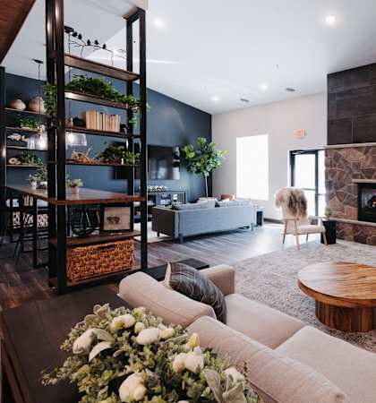 a living room with a couch and a table and a fireplace