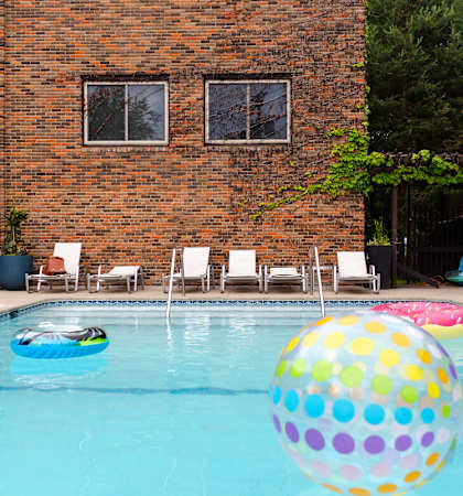 A pool with a multicolored ball floating in it.