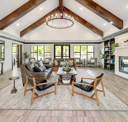 A living room with a large couch, a chair, and a coffee table.