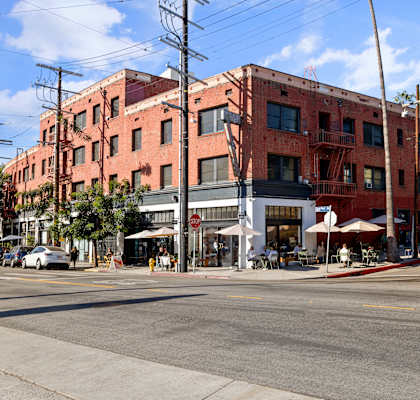 a large brick building on a city street at Del Mor Apartments, Los Angeles, California