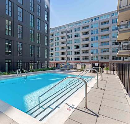 A swimming pool in front of a building.