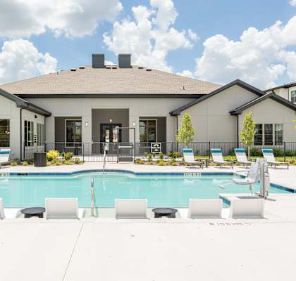 A large house with a pool in front.