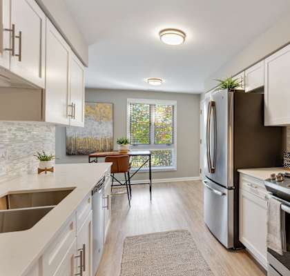 A contemporary apartment kitchen with stylish fixtures.