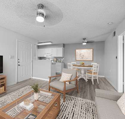 A living room with a television, a couch, and a coffee table.