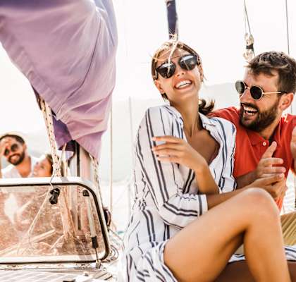 a man and a woman sitting on a sail boat