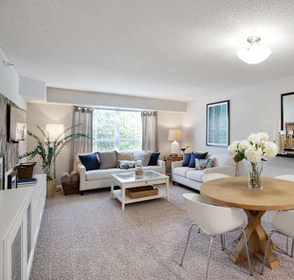 a living room with a table and chairs and a couch