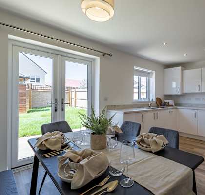 A modern dining room with a table set for two.
