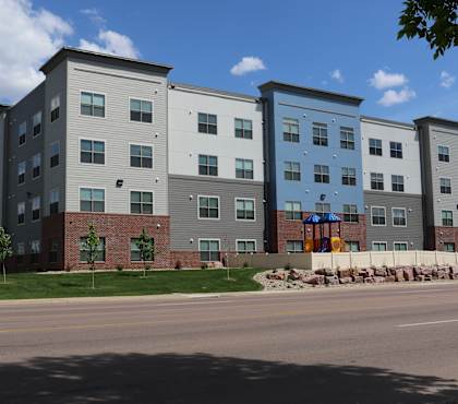 A large apartment complex with multiple buildings and balconies.
