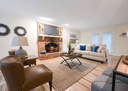 A living room with a fireplace and a couch.