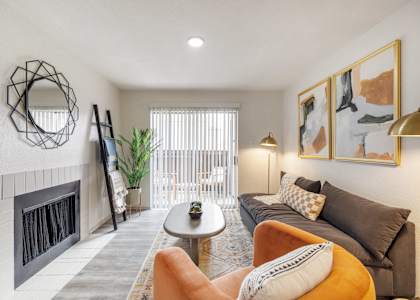 a living room with a couch and a fireplace