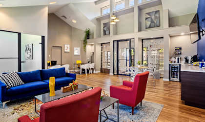 a living room filled with furniture and a large window