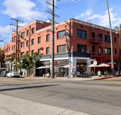 a large brick building on a city street at Del Mor Apartments, Los Angeles, California