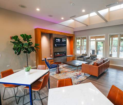 A living room with a white table and chairs.