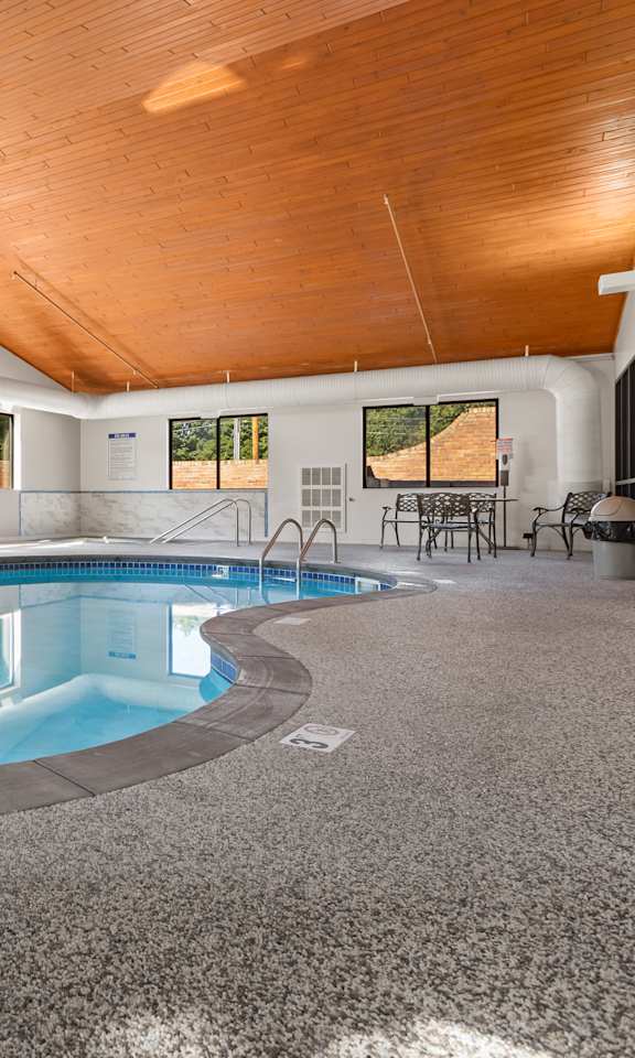 A large indoor swimming pool with a wooden ceiling.